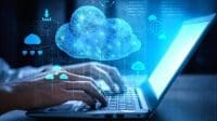Persons hands on a laptop with cloud services